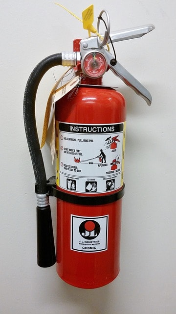 Fire extinguisher mounted on commercial building wall