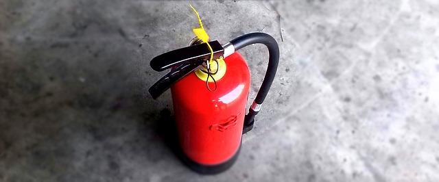 Fire extinguisher ready for inspection and servicing at a commercial property