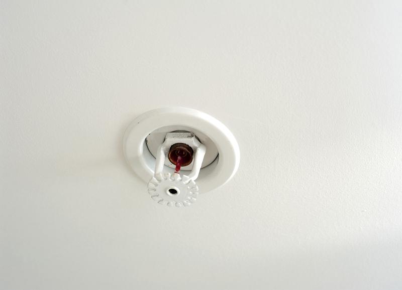 Ceiling-mounted automatic fire sprinkler head in a commercial building