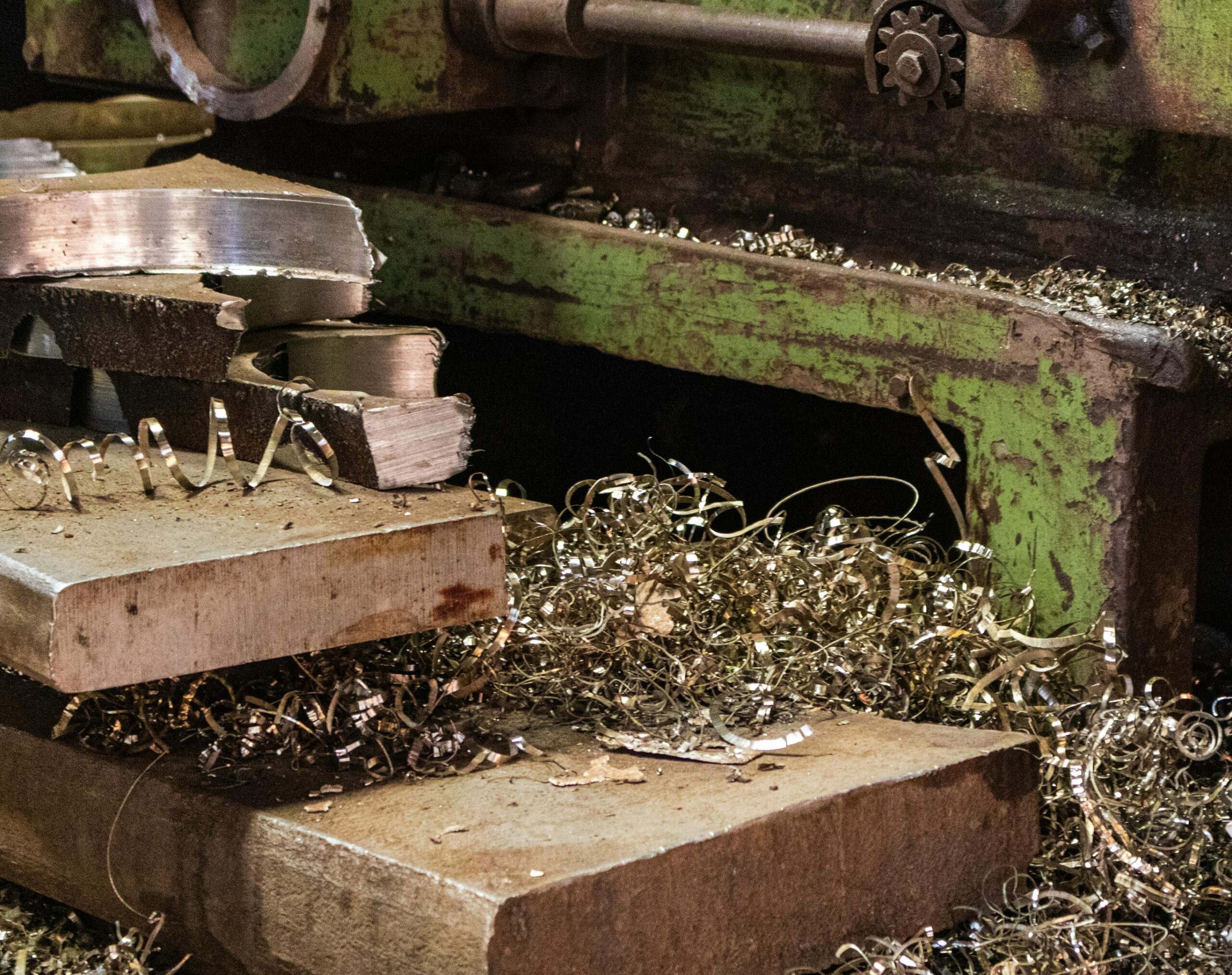Metal shavings around industrial machining equipment in a workshop